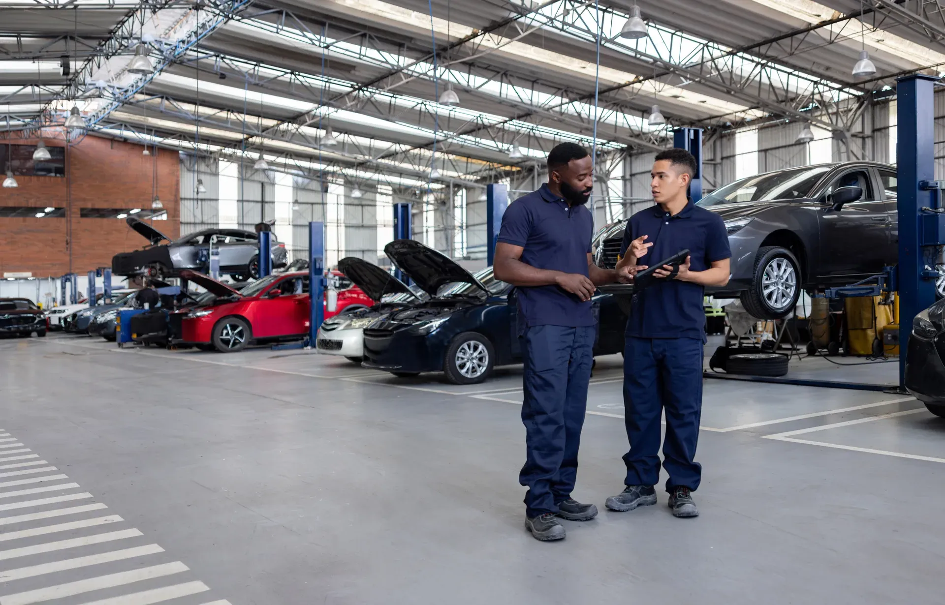 Technicians reviewing a repair plan in the Prime Auto Body shop