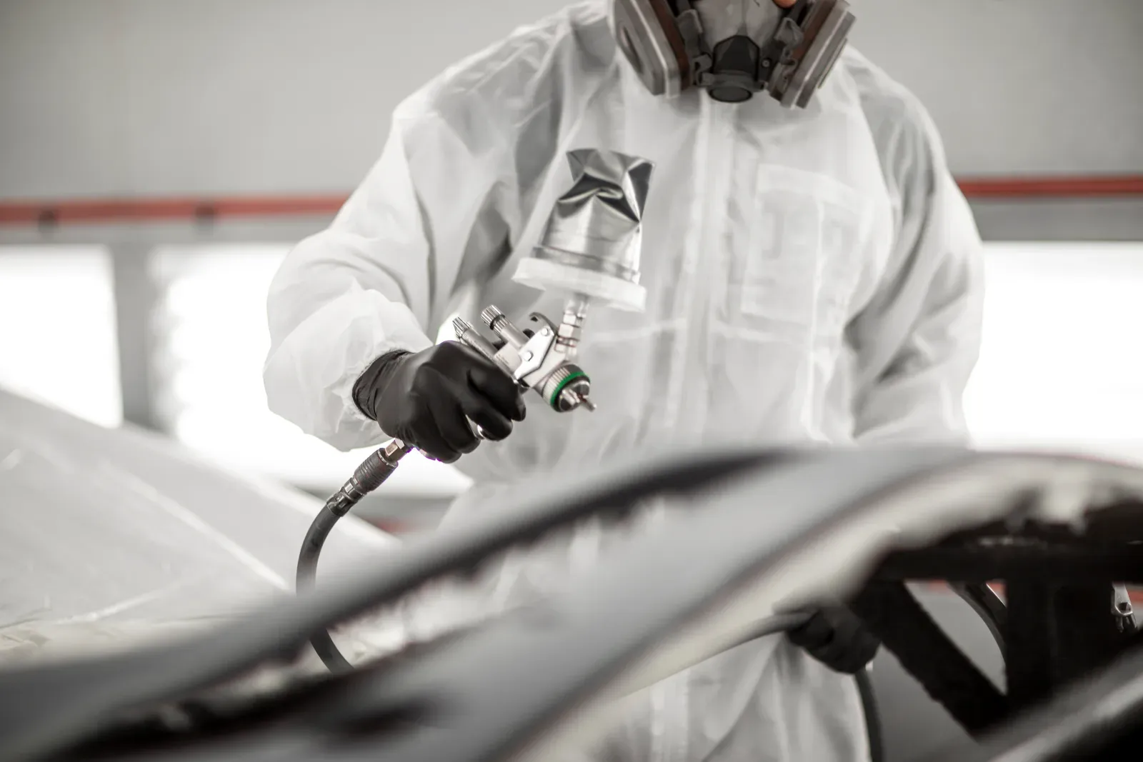 Painter spraying a panel